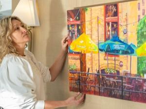 Dawn Schmidt with one of her paintings at the Fairmont Hotel in downtown Winnipeg.