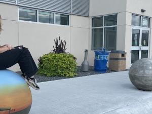 Jessica Banman and her paintings on the CRRC bollards.