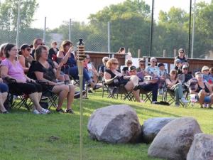 Visitors gather for a concert in the park last summer in Grande Pointe.