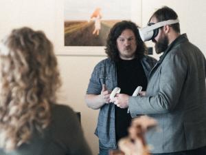 Rory Hiebert helps new-to-VR users explore his online art gallery.