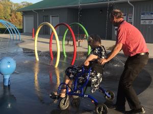 91-year-old Emily Fast wheels through the splash pad.
