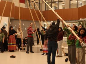 Students gather to erect NHS's teepee.