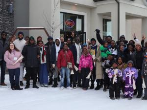 A group of new French-speaking immigrants from Africa take a tour of Île-des-Chênes.