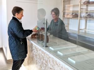 Employee Liesa Funk interacts with a customer on the first day of business at Forgotten Flavours’ new Niverville storefront.