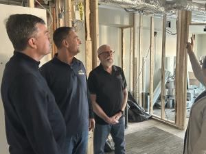Mayor Myron Dyck, Councillor Nathan Dueck, and Deputy Mayor Chris Wiebe tour the expansion underway at Open Health Niverville.
