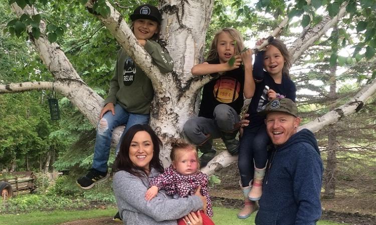 Jordan St. Cyr with his wife Heather and their four children, in his hometown of Niverville.