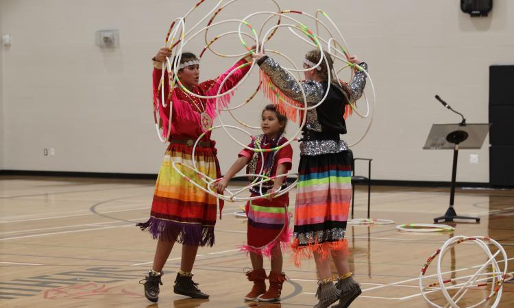 Kimberly, Charisma, and Nakiyah Mason perform the hoop dance at NHS.