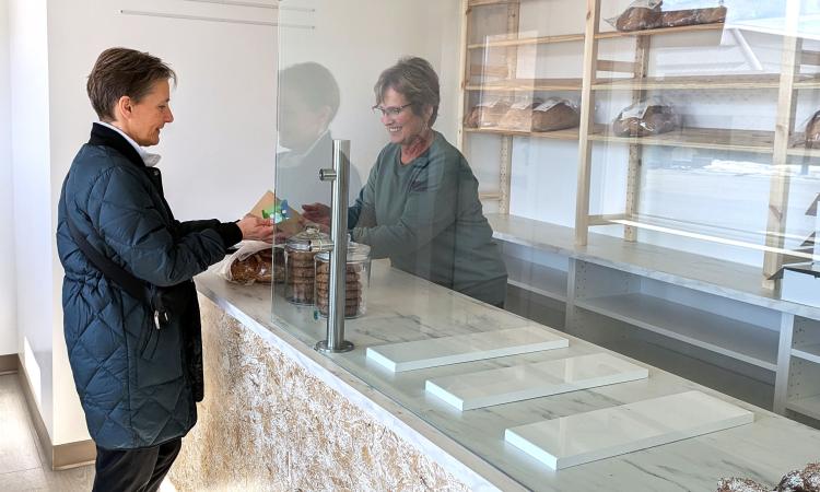 Employee Liesa Funk interacts with a customer on the first day of business at Forgotten Flavours’ new Niverville storefront.