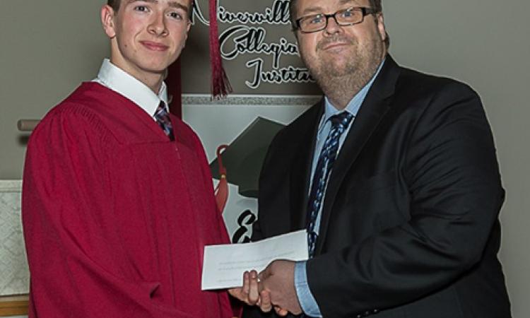Riley Hiebert accepting The Citizen bursary from editor Evan Braun