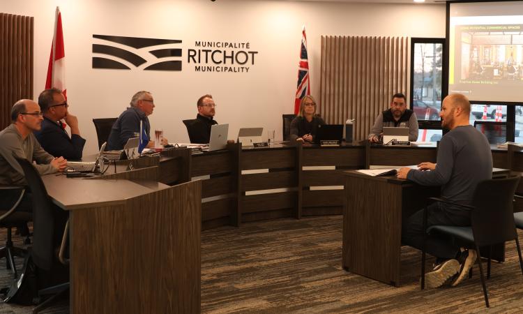 Developer Luke Wiebe address Richot's council about a revised multifamily housing proposal.