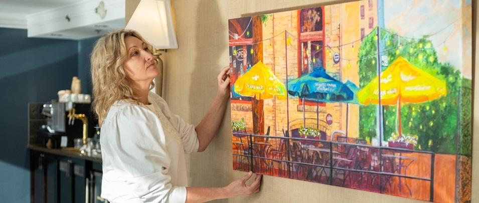 Dawn Schmidt with one of her paintings at the Fairmont Hotel in downtown Winnipeg.