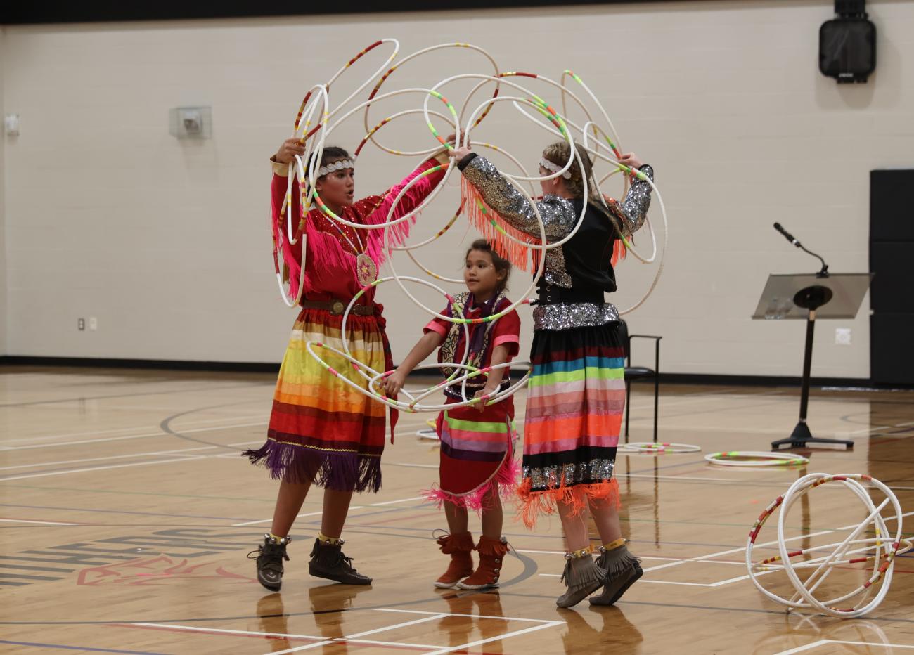 Kimberly, Charisma, and Nakiyah Mason perform the hoop dance at NHS.