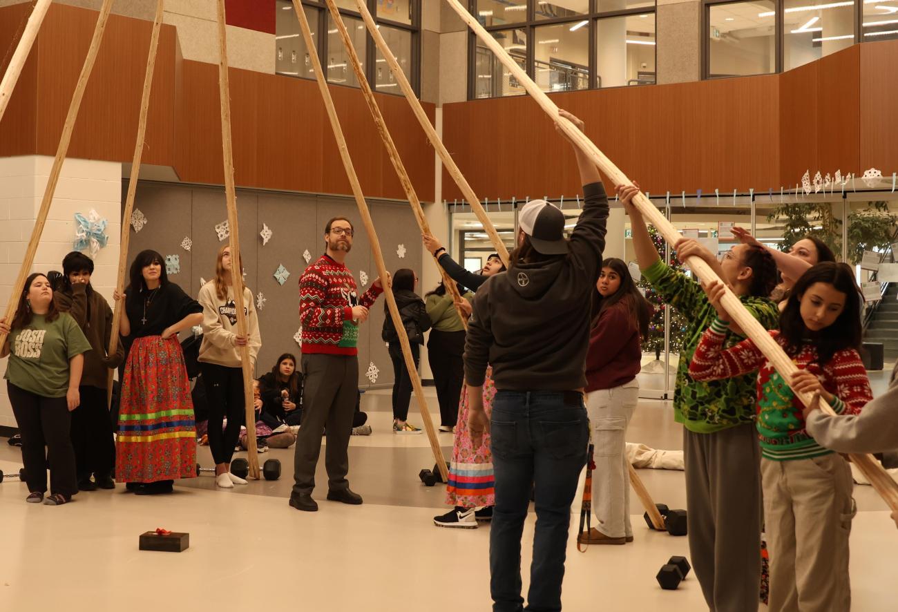Students gather to erect NHS's teepee.