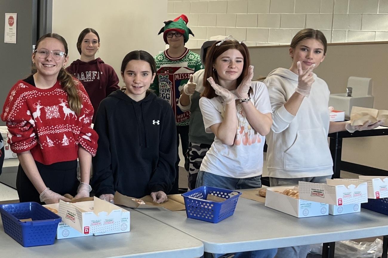Students sell Krispe Kreme donuts in support of Water for South Sudan.