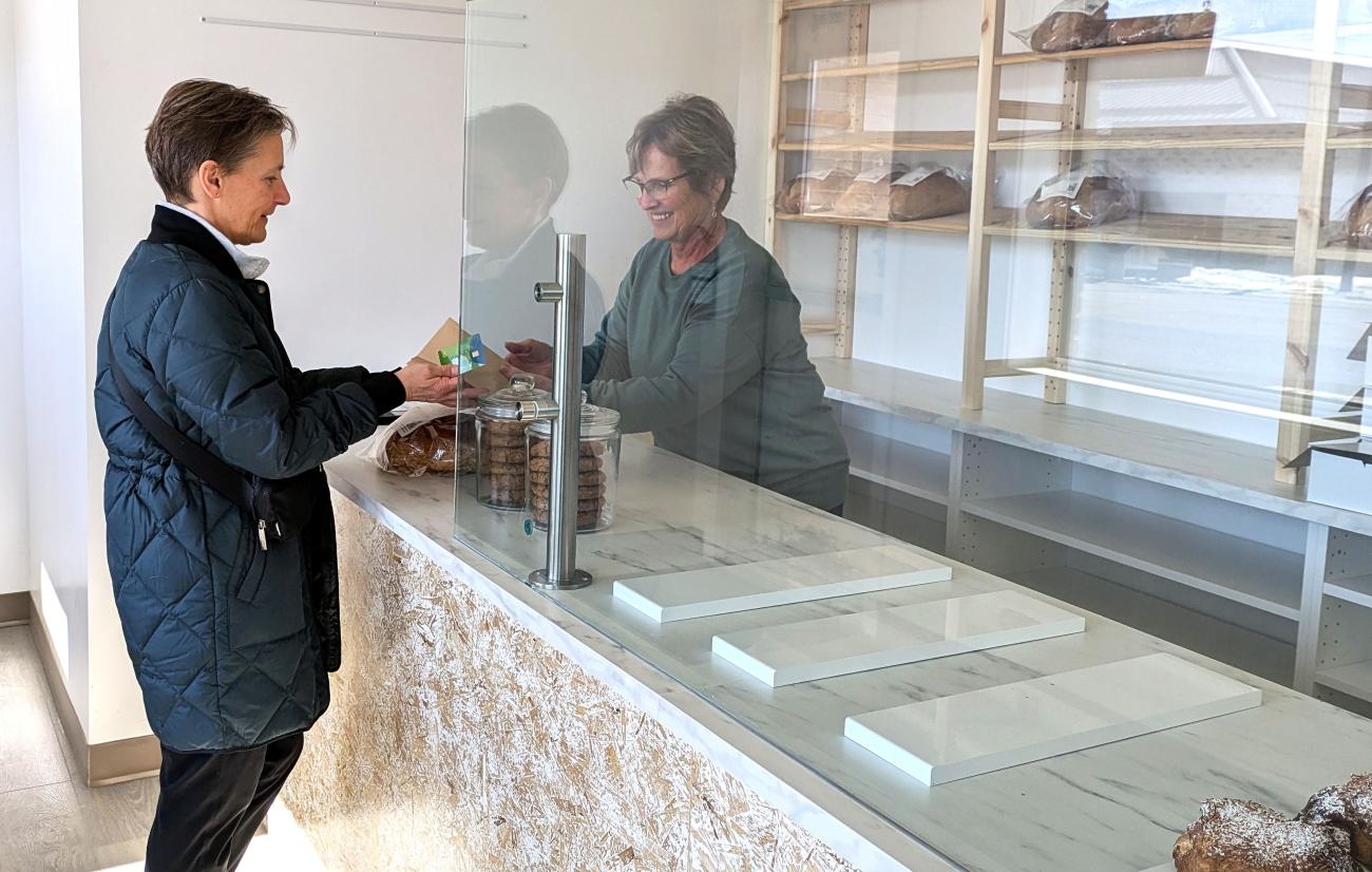 Employee Liesa Funk interacts with a customer on the first day of business at Forgotten Flavours’ new Niverville storefront.
