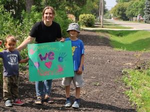 Crystal Isaak and her two children after the sidewalk along First Street South was removed this summer.