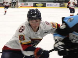 Defenceman Ethan Kelly goes to the boards during the Nighthawks' 6-0 victory against the Winnipeg Freeze.