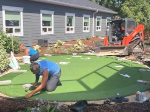 Installing the putting green at the Memory Garden at Niverville's PCH.