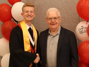 Sandy Wallace presenting the Manitoba Credit Unions Award to Jack Grantham.