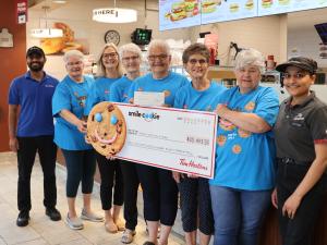 Volunteers for Niverville's mobility van fundraising committee receive a cheque from the Niverville Tim Horton's staff.