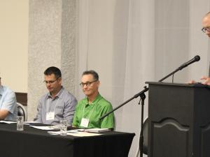 Bruce Duggan of Providence College (Otterburne), Paul Neufeld of Southern Comfort Mechanical (Niverville), and Gary McFarlane of Titan Environment Containment (Île-des-Chênes) speak on a panel moderated by Darren Swanson of the International Institute for Sustainable Development.