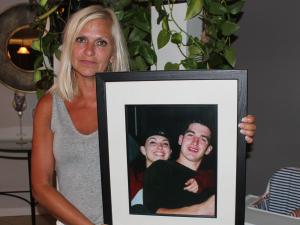 Mona Stott holds up a picture of her children, Danielle and Joey.