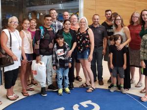 A refugee family is greeted at the Winnipeg airport by members of Open Doors Niverville.