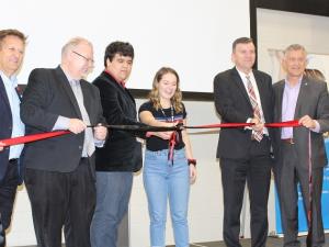 The ribbon-cutting ceremony, with MLA Ron Schuler, Minister of Education Kelvin Goertzen, students Dominic Augusto and Katey Hiebert, Mayor Myron Dyck, and MP Ted Falk.