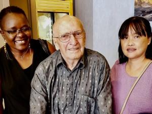 John Plett alongside PCH aides Grace and Li.