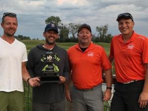 Cory Funk and Kurt Funk receive their championship trophy from last year’s winners, Bryan Trottier and Ray Dowse.