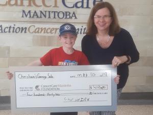 Christian Harder with a staff member from Cancer Care Manitoba.