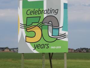 Fiftieth anniversary signs greet visitors to Niverville at either end of town.