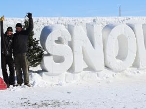 Angie and Clint in front of their record-breaking snow maze near St. Adolphe.
