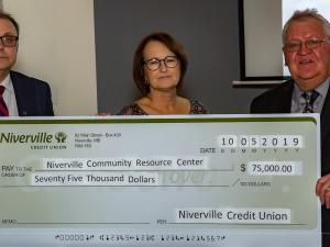 Ken Rempel and Nancy Penner of the Niverville Credit Union present a cheque to fundraising co-chair Clarence Braun.