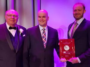 Bothwell cheesemakers Nathan Dueck (centre) and Paul Meyer (right) accept their silver medal.
