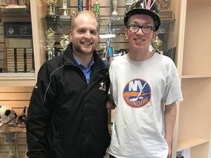 Coach Colin David and Riley Weir, wearing the Cavaliers hardhat.