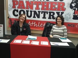 Leslie Bardal (left) and Heather Miller (right) at a PAC kiosk.
