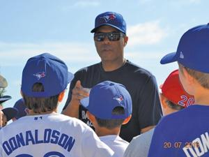 Former Blue Jay Roberto Alomar working with young players at the 2016 baseball camp.