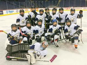 The Atom A Clippers at centre ice at Bell MTS Place