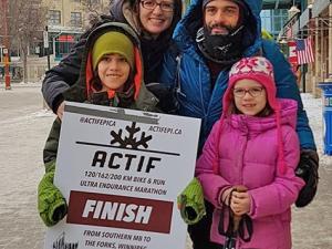 Joao is greeted by his family at the end of the race