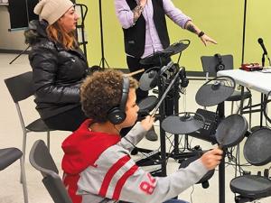 Elijah and his mom pick up the sticks at Niverville Winterfest with Kirkwood's encouragement