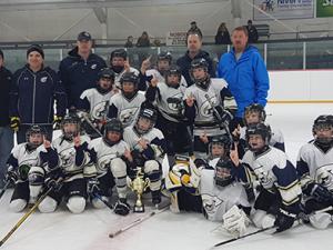 The Clippers Atom A team celebrates their victory