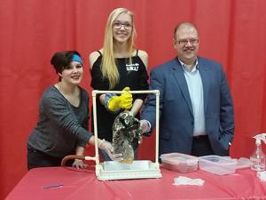 Kianne Prudhomme, Shelah Klassen, and the Hon. Kelvin Goertzen examine a mock-up of a diseased lung