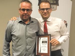 Chris Ewen (right) presents award to Alain Robert, owner of Ste Agathe Service (left