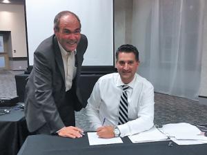 Nathan Dueck getting sworn in by Chief Administrative Officer Jim Buys
