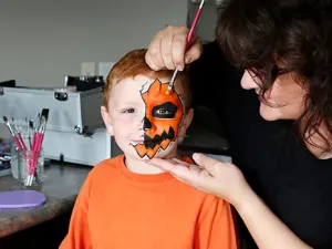 Eileen Davage painting her son Sam's face