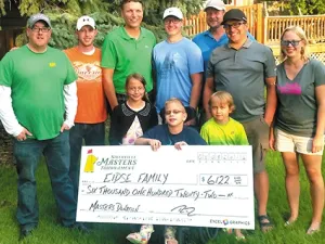 Joel Martens, Tyler Wiebe, Ray Dowse, Stanley Hiebert, and Collin Funk present a cheque to the Eidse family of Niverville