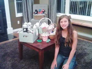 Briana Bloom, 14, poses with her sock puppet creations