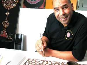 Ahmed Laarissa with some of his Moroccan paintings