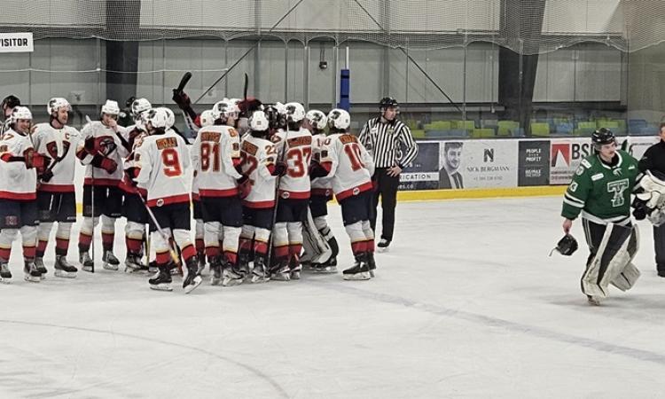 The Nighthawks celebrate their shootout victory against the Portage Terriers.